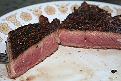 Meat with a dark exterior, common in high temperature cooking