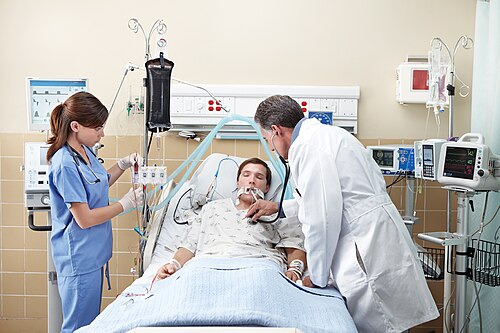 A patient and clinicians in an intensive care unit