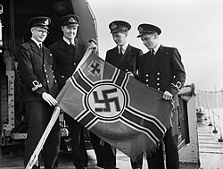 Royal Navy officers with a captured Reichskriegsflagge from an e-boat, 1944
