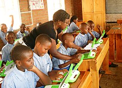 Children in a Rwandan primary school, using laptops supplied by the One Laptop Per Child programme