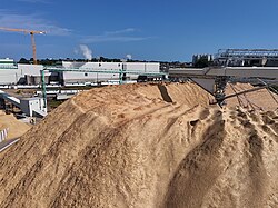 A wood-chip stockpile with elevated conveyor systems