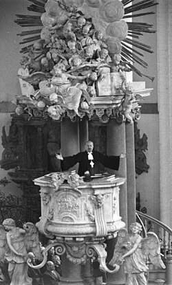 Otto Dibelius preaching from the pulpit (1703 by Andreas Schlüter) in St. Mary's Church, Berlin (East), 1959
