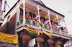 A building with purple, green, and gold banners and decorations during Mardi Gras in 1999.