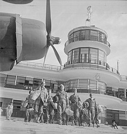British prisoners of war evacuating in 1945 following the Japanese surrender at Kallang Airport. The airport's control tower, located near the city, has been conserved.