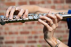 A flautist playing a Western concert flute