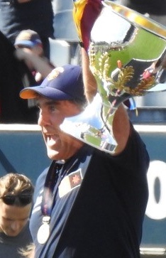 Craig Starcevich holding the AFLW premiership cup in 2023.