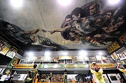 The painting on the ceiling was inspired by The Creation of Adam and depicts Lionel Messi and Diego Maradona at the front, with other notable footballers such as Juan Román Riquelme, Gabriel Batistuta, Mario Kempes, Sergio Agüero, Claudio Caniggia, Ricardo Bochini and Ariel Ortega at the background