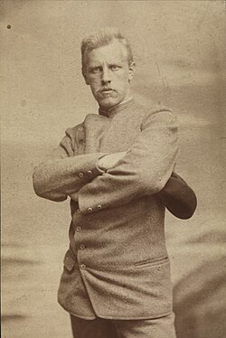 Portrait of a stern and determined looking man with arms crossed.