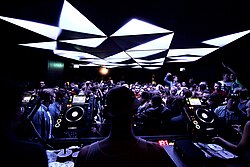 Club DJ using digital CDJ players for mixing music (Munich, 2010s)