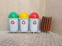 Common bins for recyclable waste along with a bin for unrecyclable waste. The bin with a yellow top is labeled "aluminum". Rhodes, Greece.