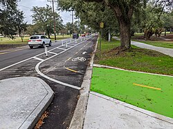Bike lane separated by plastic delineators, New Orleans[contradictory]