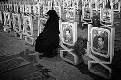 An Iranian mother mourning her son in a military cemetery in Isfahan, 2011.