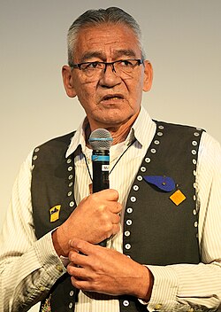 Hereditary Chief Na’Moks of the Wet’suwet’en Nation introduces the documentary film Yintah at a screening in Berlin on 9 December 2024