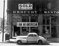 A Japanese-American unfurled this banner the day after the Pearl Harbor attack, but he was later detained. This Dorothea Lange photograph was taken in March 1942, just prior to the internment of Japanese Americans.
