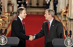 Shaking hands with Bush after their press conference in the East Room of the White House, November 2004