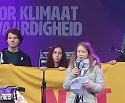 Thunberg wearing a keffiyeh in solidarity with Palestine at an event in Amsterdam in 2023
