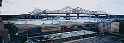 The New Orleans Morial Convention Center, and in the background, the Crescent City Connection bridge over the Mississippi River.