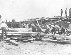 Workers clearing up debris at the Poland Station streetcar barn in New Orleans after the hurricane