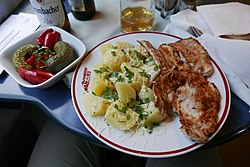 Baked potatoes with steak and cucumber salad