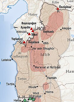 Areas of conflict and displacement (light purple), refugee camps (red triangles), displaced in host homes (green houses), FSA held territory (red), June 2012.[253][254]