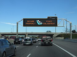 English and French displayed on a gantry sign. Communities with sizeable francophone populations are able to receive provincial services in French.
