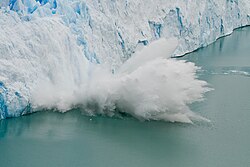 Glacier calving happens when large chunks of ice collapse into the body of water as the glacier advances