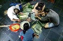 A family gathering to make bánh tét for the Vietnamese New Year celebrations