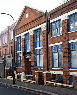 exterior of red brick building with classical-style columns and pediment