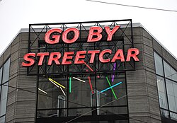 A sign in Portland that reads "go by streetcar". Trams are often called streetcars in North America.