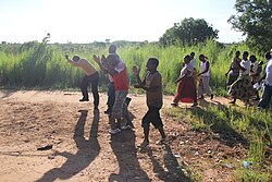 Villagers making a transect walk or 'walk of shame' to the open defecation places, singing 'let us end open defecation' (a village near Lake Malawi, Malawi)