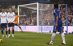 A player (blue) about to take a free kick