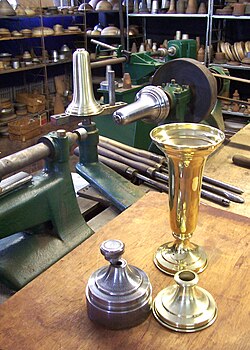 A metal spun brass vase