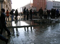As Climates change and water levels rise, tourism will have to continue to adapt. Seen here with raised platforms to help tourist and locals get around a flooded Venice, Italy.