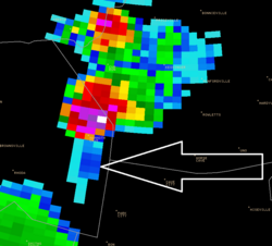 Example of a three-body spike: the weak triangular echoes (pointed by the arrow) behind the red and white thunderstorm core are related to hail inside the storm.