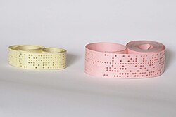 Punched tapes were used in early computers to store and represent data.