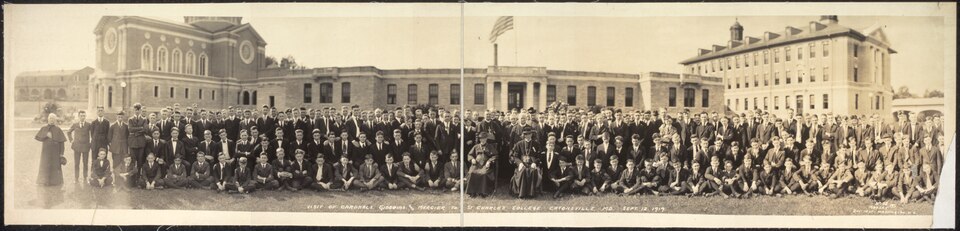 Cardinals James Gibbons (also Archbishop of Baltimore) and Désiré-Joseph Mercier, the Primate of Belgium, visit St. Charles College on September 12, 1919, eight years after the great fire, with only the lower level of the center section completed