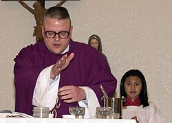 A priest blesses ashes.