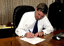 Coalition Provisional Authority director L. Paul Bremer signs over sovereignty to the appointed Iraqi Interim Government, 28 June 2004