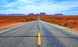 The West, as the most recently settled part of the United States, is often known for broad highways and open space. Pictured is a road in Utah to Monument Valley on the Navajo Nation.