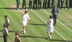 Federer celebrates his eighth Grand Slam title after a win over Nadal.