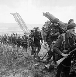 Royal Marine Commandos attached to 3rd Division move inland from Sword Beach on the Normandy coast, 6 June 1944