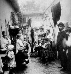 Italian immigrants in a conventillo in Buenos Aires. Italian is the largest single ethnic origin of European immigrants in the country, and became a major part of modern Argentine society.[27][28]