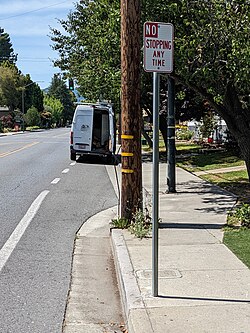 A van parked in an unprotected bike lane