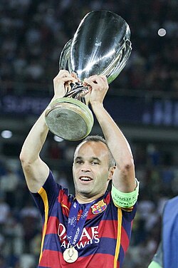 Iniesta lifting the 2015 UEFA Super Cup trophy