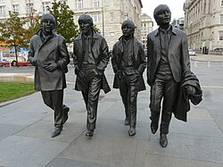 The Beatles statue at Pier Head. The group are the most commercially successful and critically acclaimed band in popular music.[446]