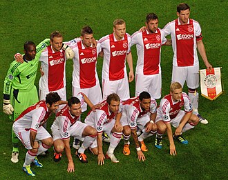 2011 AFC Ajax team wearing its home kit by adidas with the AEGON sponsor across the chest, ahead of its UEFA Champions League match against Olympique Lyonnais.