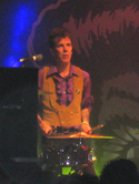 Slim Jim Phantom playing a two-piece kit while standing.