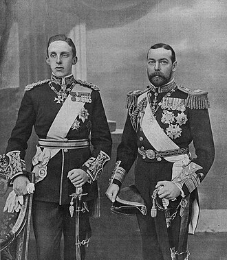 Alfonso XIII of Spain (left) with his cousin-in-law, the future King George V (right), during his State Visit to the United Kingdom in 1905. Alfonso is wearing the uniform of a general of the British Army, the Royal Victorian Chain, the sash and star of the Garter, the cross of the Order of Charles III, the neck badge of the Golden Fleece, and the badge of the four Spanish military orders. George, then Prince of Wales, is wearing the neck badge of the Golden Fleece, the sash and grand cross grade of the Order of Charles III, the Royal Victorian Chain, and the stars of the Garter and the Order of St Michael and St George.