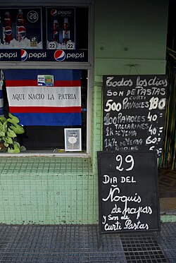 Billboard in front of a grocery store announcing "Gnocchi del 29" in the Soriano Department, Uruguay