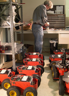 A robot technician builds small all-terrain robots (courtesy: MobileRobots, Inc.).